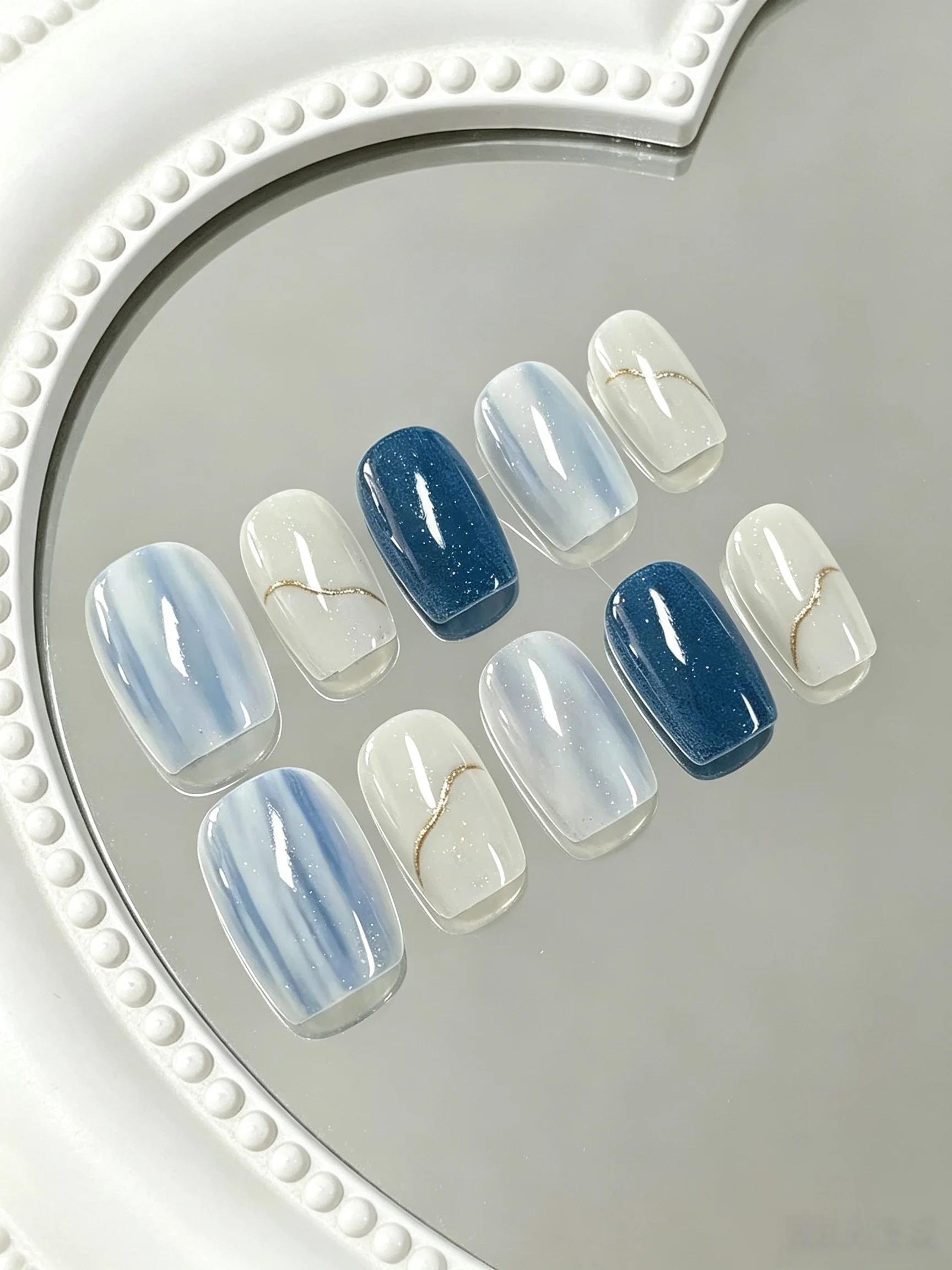 10-Piece Set of Klein Blue Gradient Nails with Gold Lines, Short Square Round Shape, Cool Water Mist Design, Includes a Nail File and a Sheet of Jelly Glue