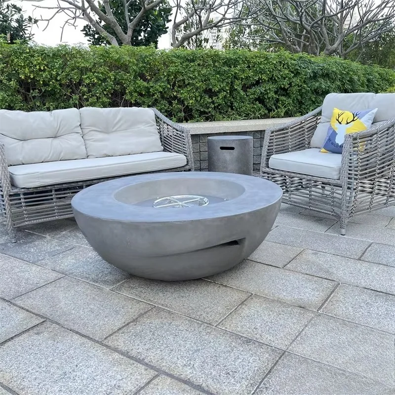 Modern outdoor round gas fire pit and brazier concrete with smooth surface and gas fuel heating