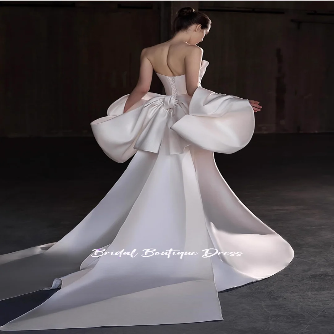 Vestidos de novia sin mangas de satén con cuentas y escote en forma de corazón personalizados, vestido de fiesta de princesa con lazo grande en la espalda