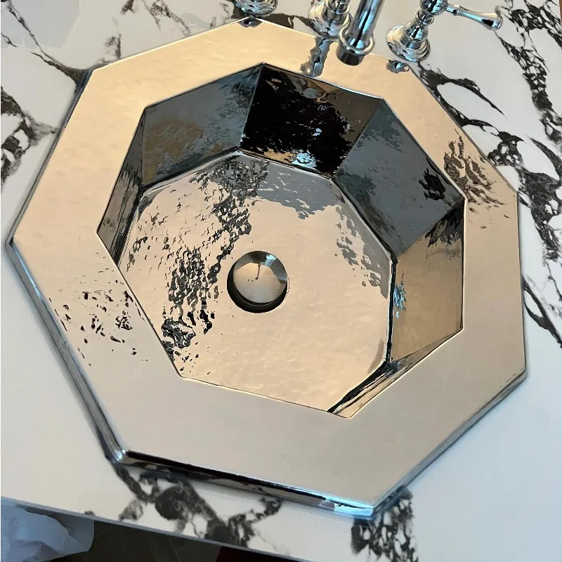 

Rosewood Hotel has the same all-copper wash basin, island high-end sink, and embedded washbasin under the counter.