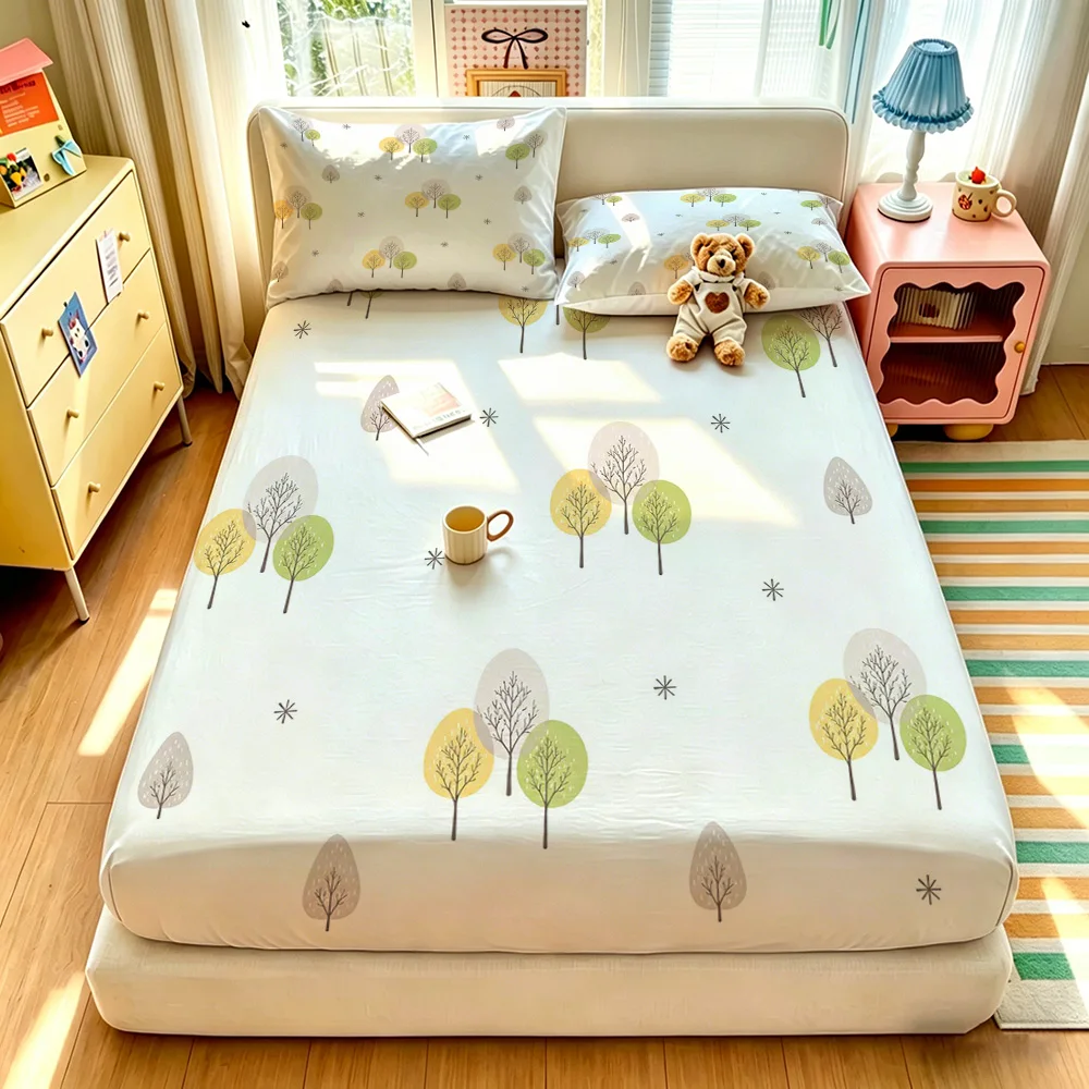 A simple three-piece bedding set featuring a tree and snowflake pattern, including a bedspread and two pillowcases