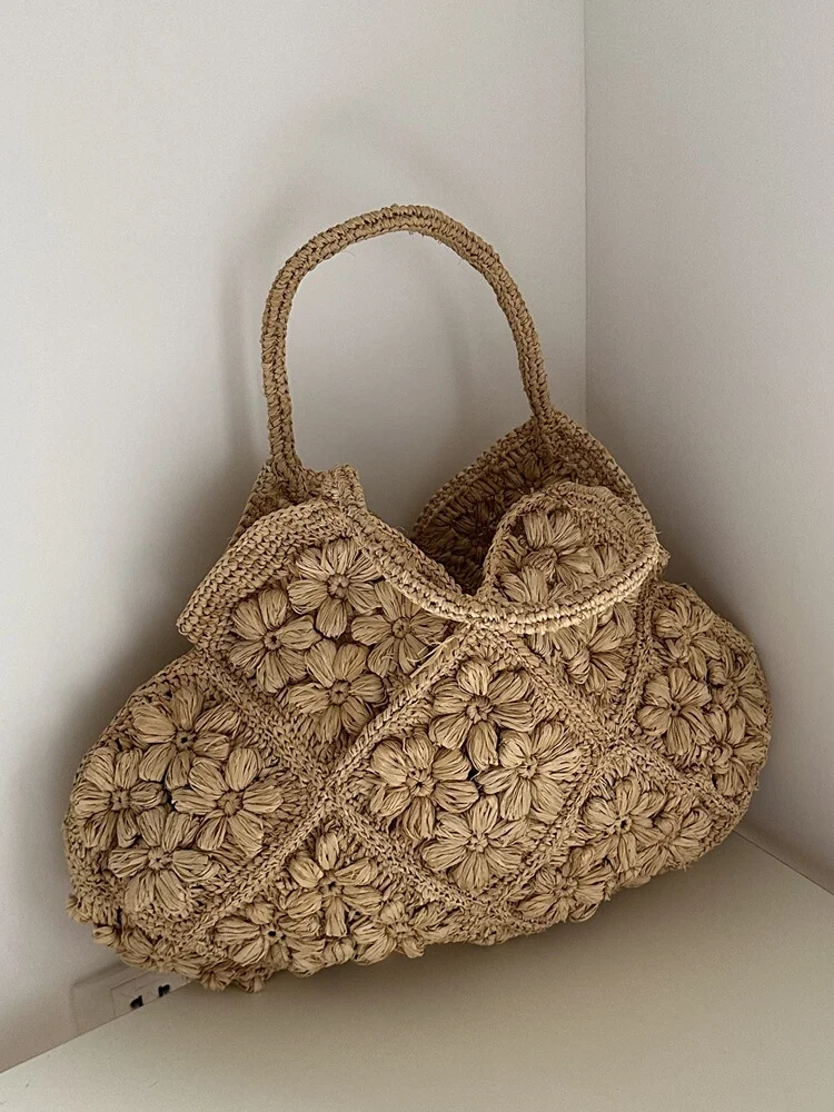 New French Handmade Lafite Grass Hollowed Out Woven Flower Petal Pattern Portable Women's Bag Seaside Vacation Fashion Bag Trend