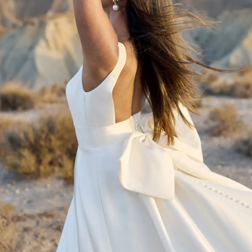 Una linea profondo scollo a V cinturino largo senza maniche abito da sposa in jersey personalizzato abiti da sposa fiocchi aperti sul retro cerniera nuovi abiti da sposa