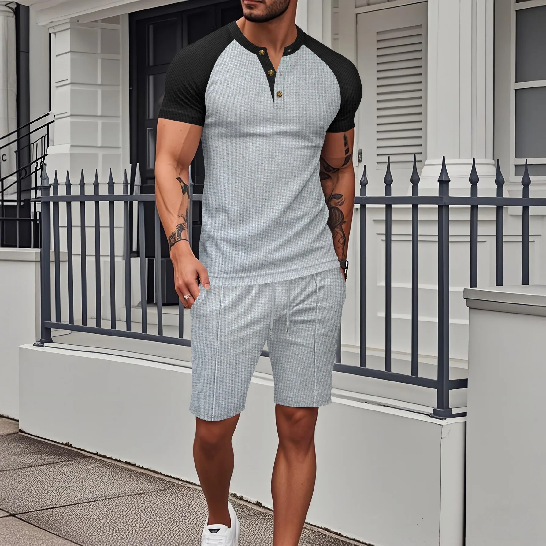 

The men's summer casual fashion two-piece set with half-buttoned T-shirt and laced shorts is suitable for sports activities.