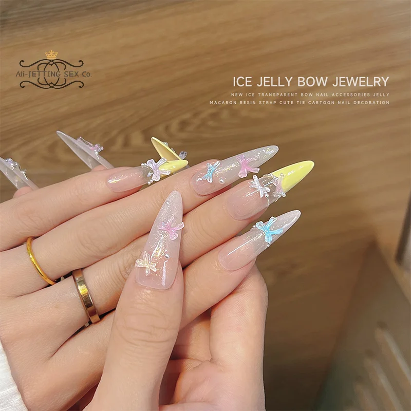 50pcs น้ําแข็งโปร่งใสสี Bowknots เรซิ่นตกแต่งเล็บ 3D มินิน่ารัก Bows เล็บ Charms สําหรับ DIY เล็บอุปกรณ์เสริม