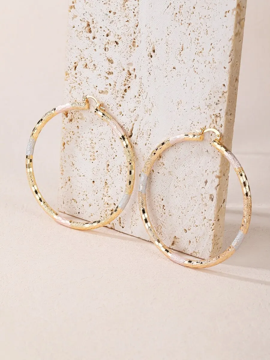 

Textured metallic hoop earrings with elegant circular design and subtle surface detail for versatile styling