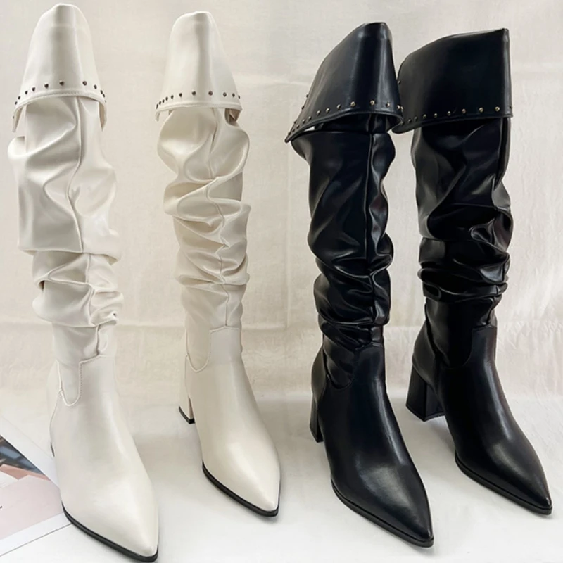 

Pointed-toe sleeve boots with rivets embellish fashionable street style outfits, dress outfits and fashion boots