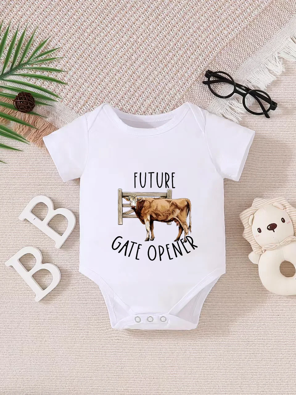 Playful letter-printed baby short-sleeve triangle bodysuit. Button closure for easy dressing