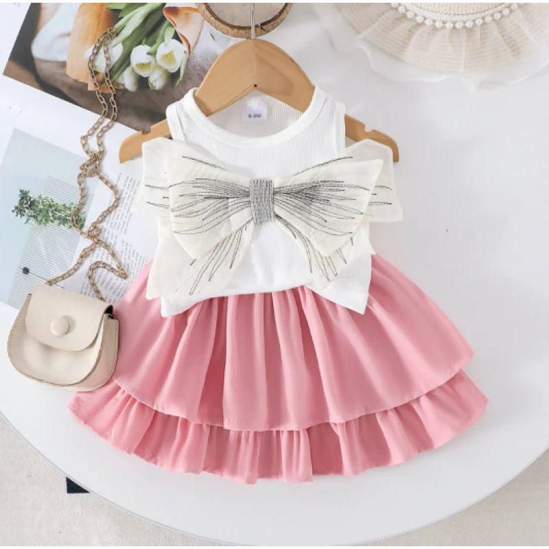 

Summer girls' outfit: white sleeveless bow top paired with black layered skirt two-piece set