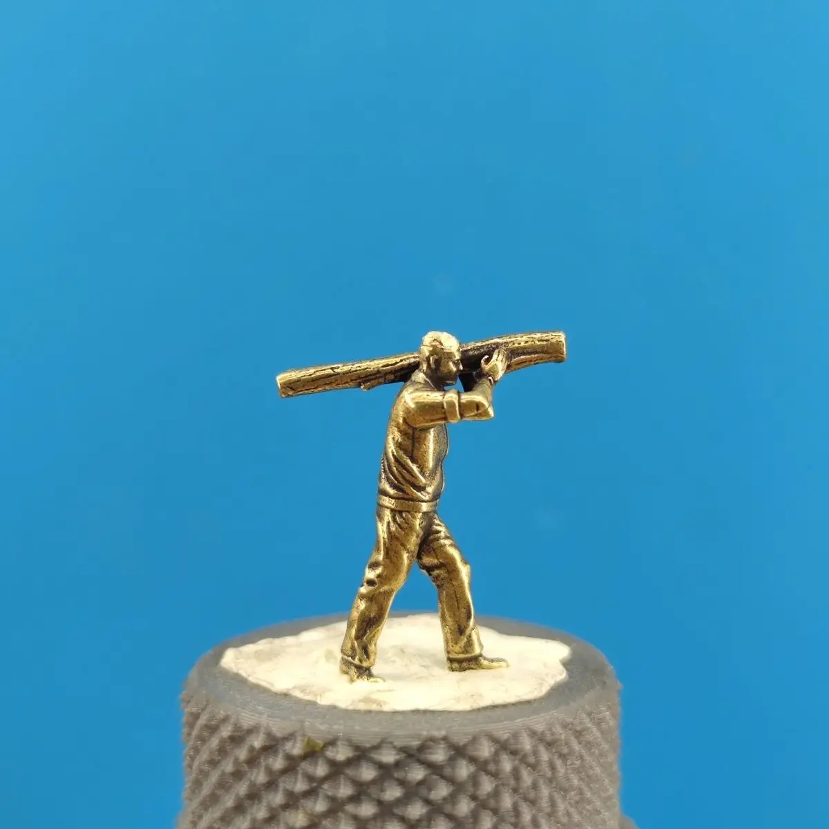 Brass-carrying wooden building transportation worker  green plant miniature scene micro photography figurine with sandbox scene