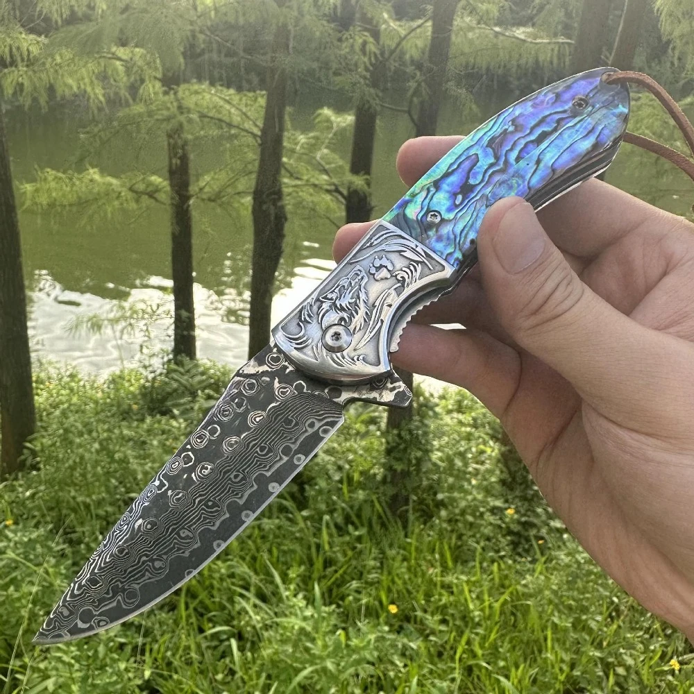Coltello pieghevole testa di lupo Lama di Damasco conchiglia manico in ebano coltello da tasca EDC da campeggio all'aperto vendita calda transfrontaliera