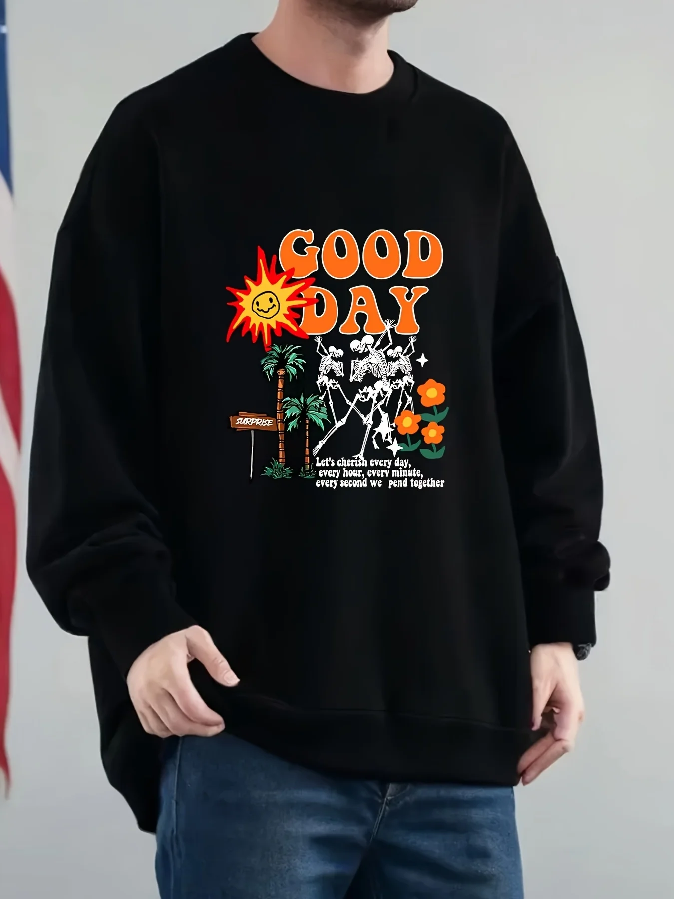 

Men's loose-patterned hoodie in black with orange "Good Day" text, palm trees and dancing skeletons