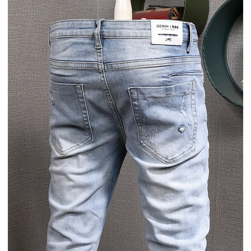 

Light colored casual jeans for men, slim fit with small feet and elastic Korean style trendy and versatile casual ripped pants