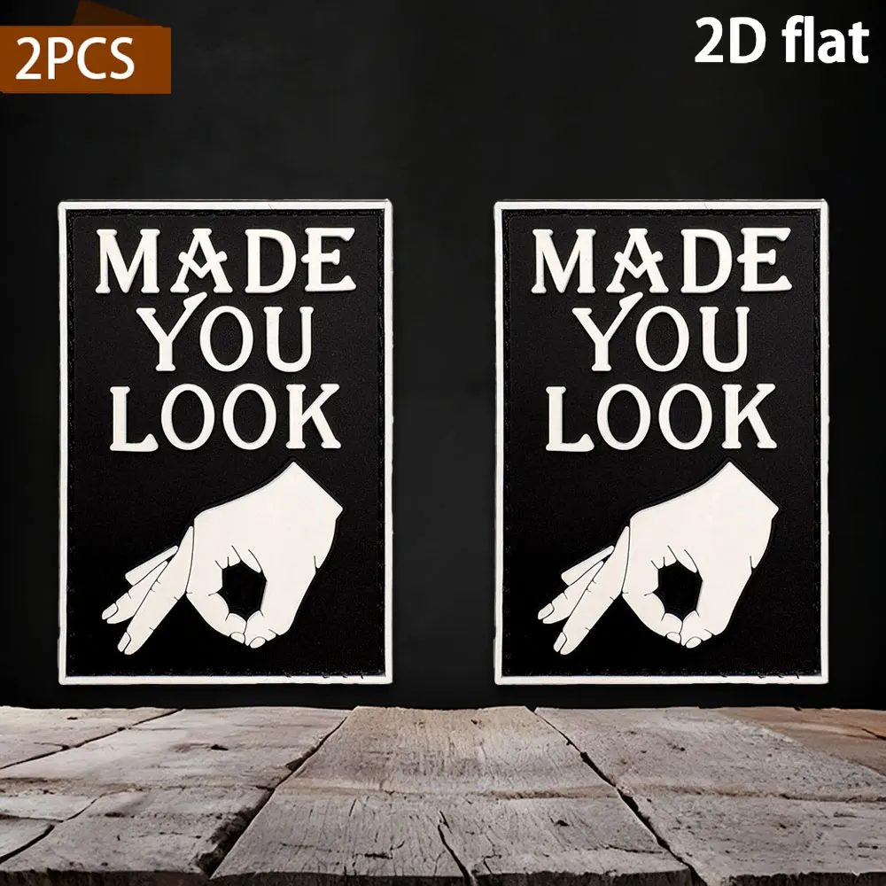 Fun dark-colored gesture pattern with English slogan, 2D flat PVC material with built-in glow-in-the-dark effect, comes with a rough-backed adhesive backing. Available in various sizes: 1pc/2pcs/3pcs. Personalized DIY versatile decorative sticker for helmets, clothing, and cycling bags
