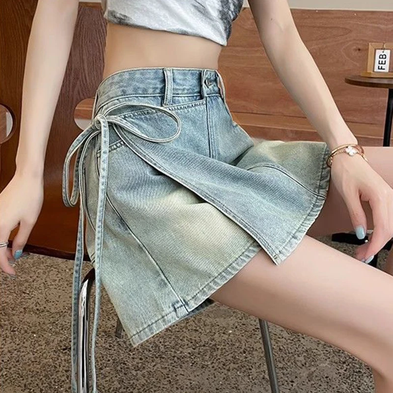 Fake two pieces of denim shorts women\'s summer new A-shaped high waist irregular western-style strap skirt slim Joker hot pants.