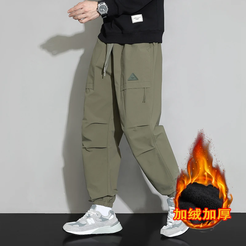 The new winter fashion brand plus cashmere foot-binding casual pants men's loose-fitting handsome all-in-one function wind