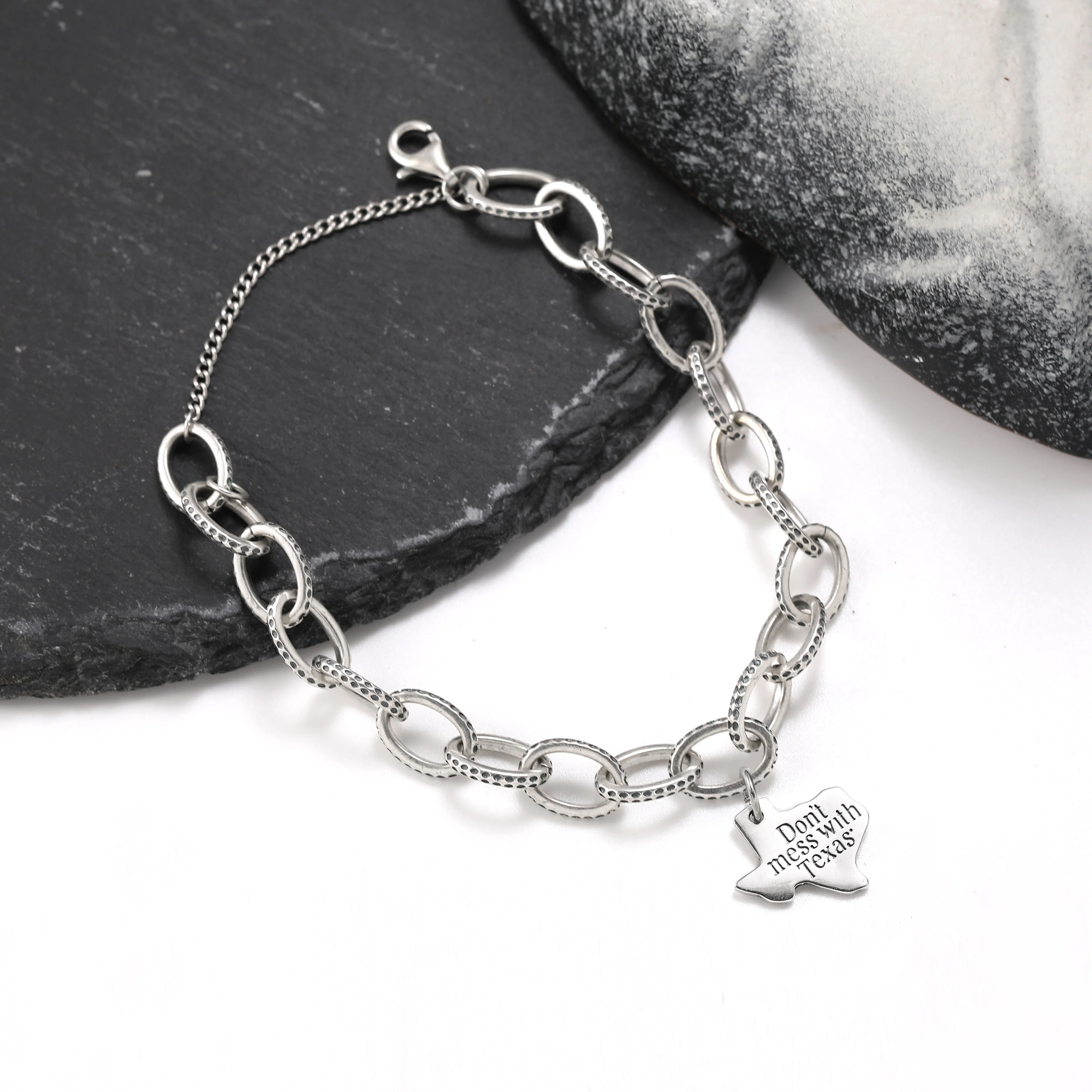 

Genuine 925 sterling silver exquisite Textured Oval Charm Bracelet paired with "Don't mess with Dezhou" pendant