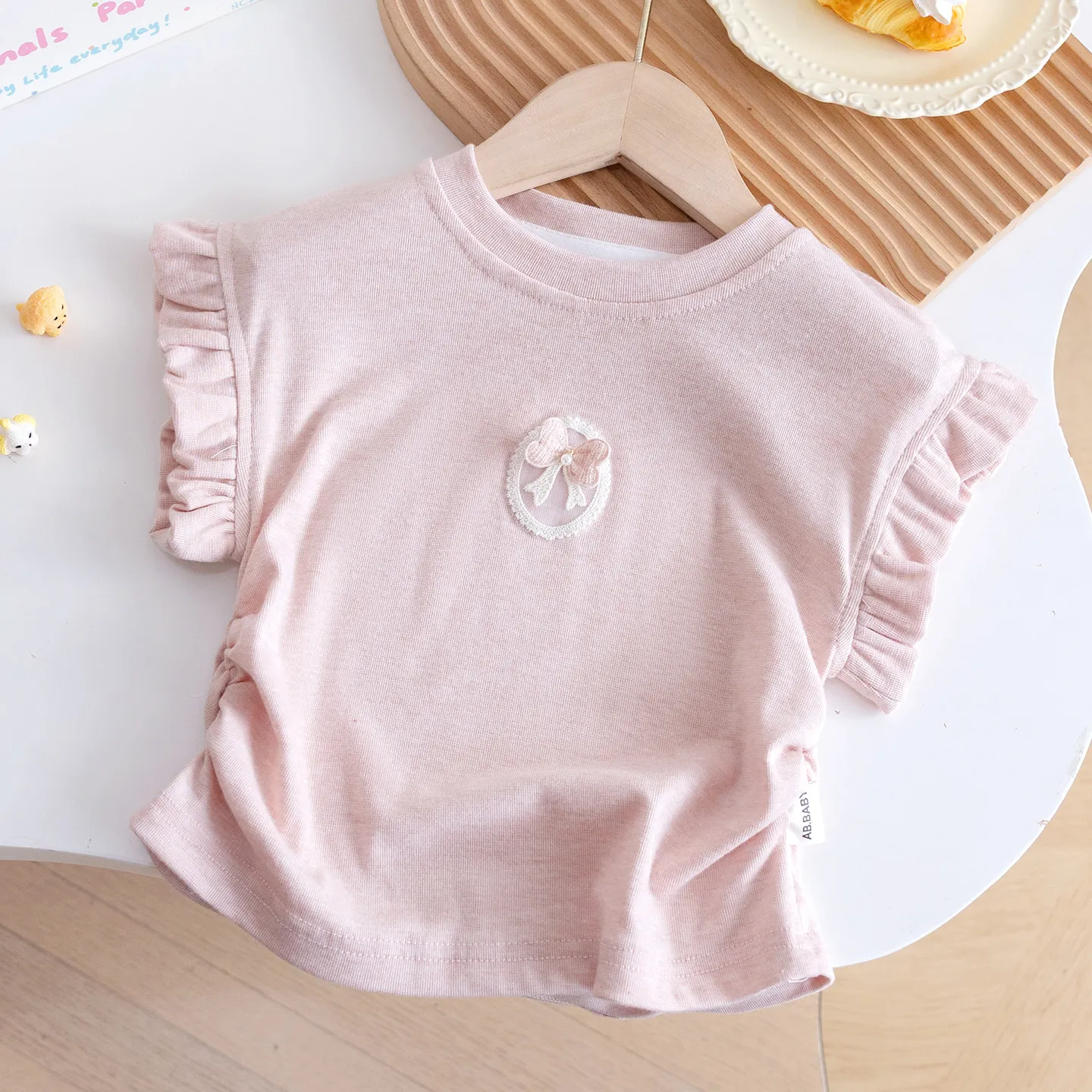 Baby girl 2026 new flutter sleeve sweet cute bow round neck top comfortable and skin-friendly short-sleeve summer wear for girls