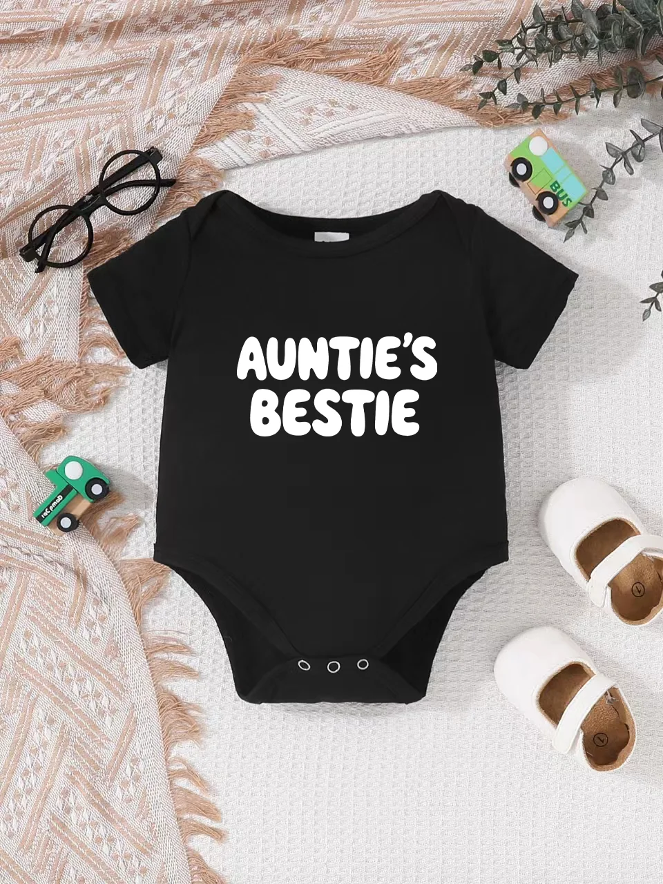 Playful letter-printed baby short-sleeve triangle bodysuit. Button closure for easy dressing, machine washable