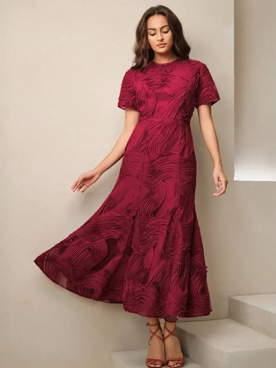

Burgundy Short Sleeve Midi Dress Featuring 3D Swirl-Textured Fabric, Round Neck, And Asymmetrical Flowing Ruffle Skirt