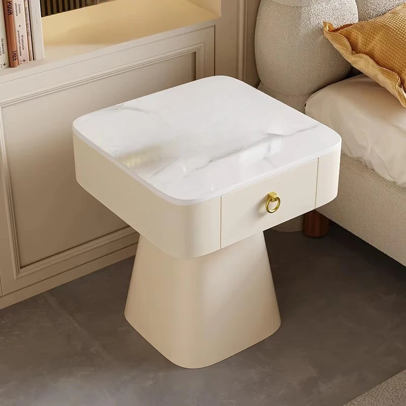 The white coffee table features a sintered stone countertop and storage drawers, with foldable solid wood legs
