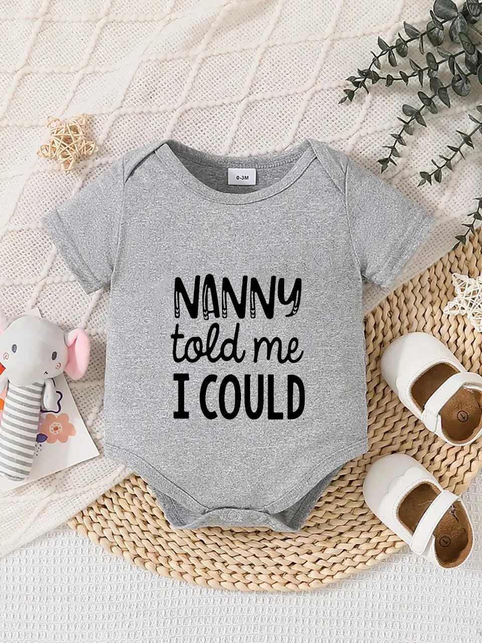 Playful letter-printed baby short-sleeve triangle bodysuit. Button closure for easy dressing, machine washable