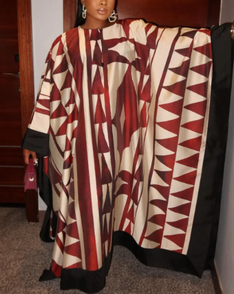 ヴィンテージプリントの流れるようなボヘミアンマキシドレス。 休日、フェスティバル、休暇に最適な女性用のリラックスしたVネック長袖ドレス。