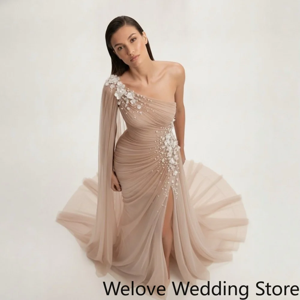 Dreamy Nude Tulle Mermaid Evening Gown Featuring Asymmetrical One Shoulder Design With Flowy Long Cape Sleeve