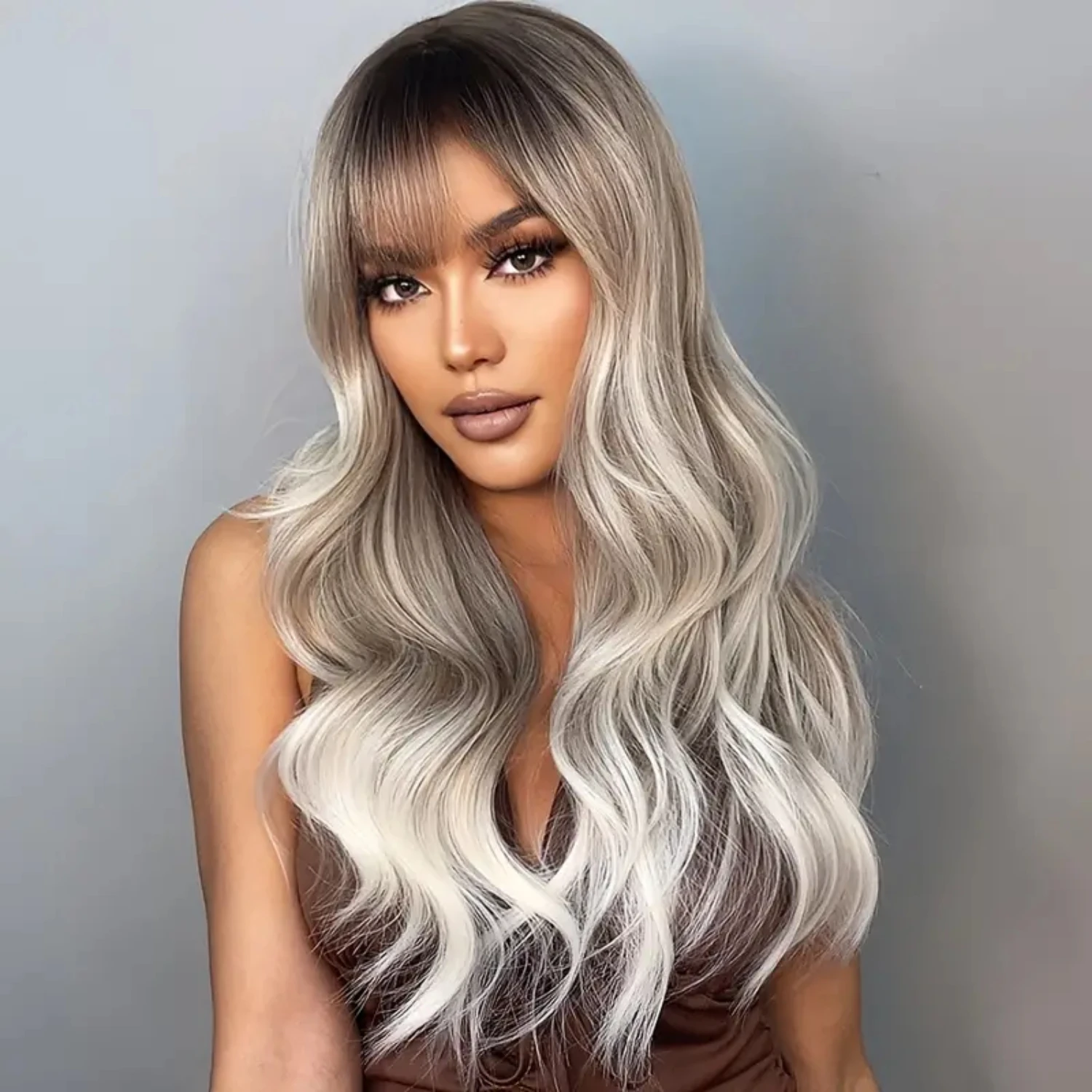 Perfectly styled for women, this 26-inch brown and blonde ombre curly bob wig with bangs is the ultimate accessory for adding vo