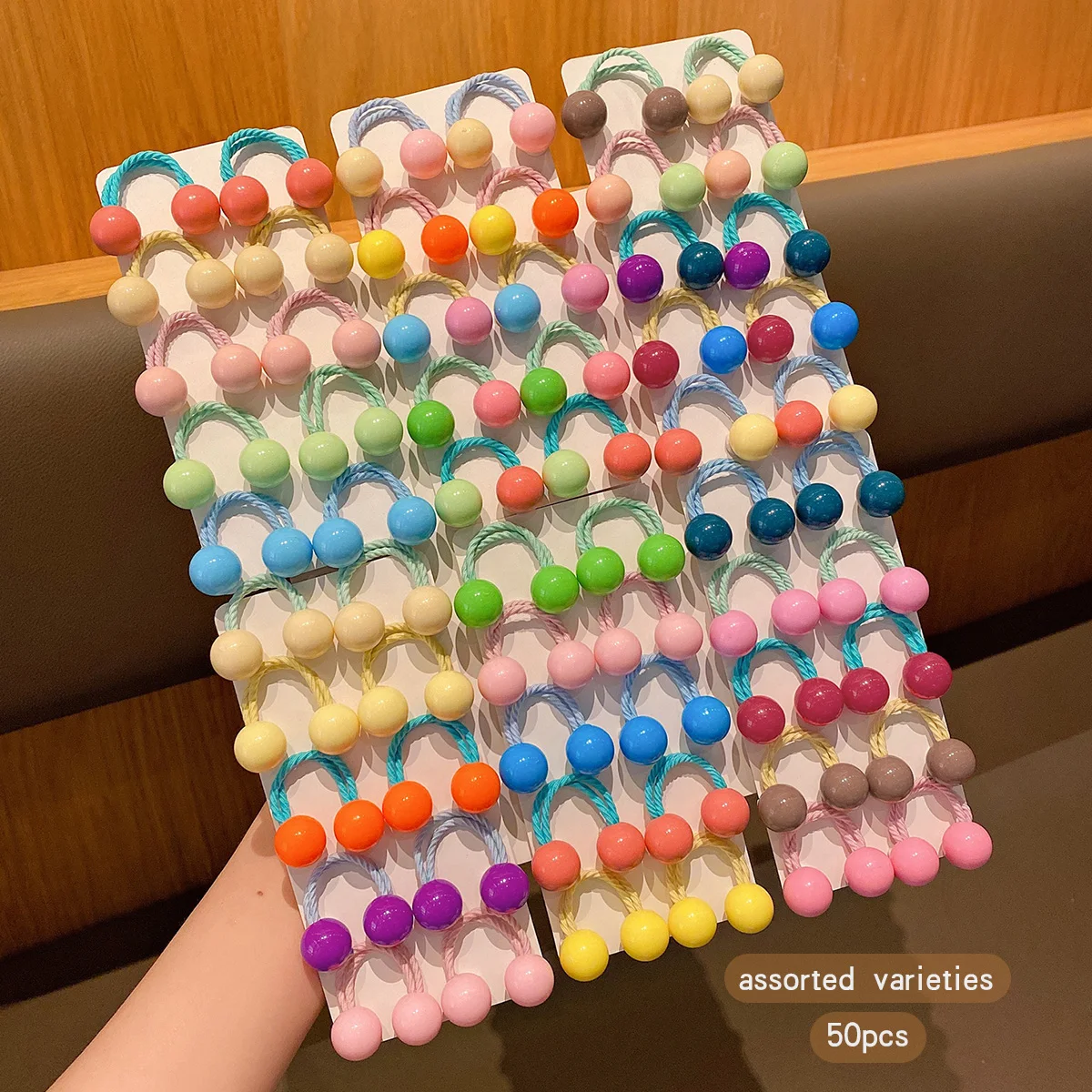 

50 button style double ended rubber bands with colorful random hair loops suitable for daily use as hair accessories