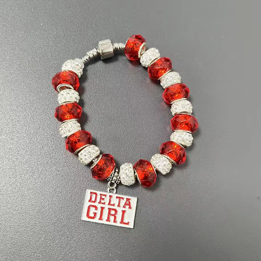 bracelet composed of red and white beads featuring Delta Greek letter shield and violet pendant.