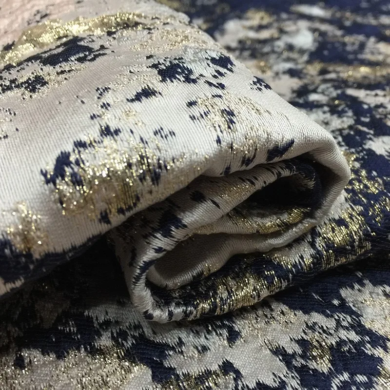 

The dress is made of jacquard fabric and brocade featuring golden thread dyed graffiti