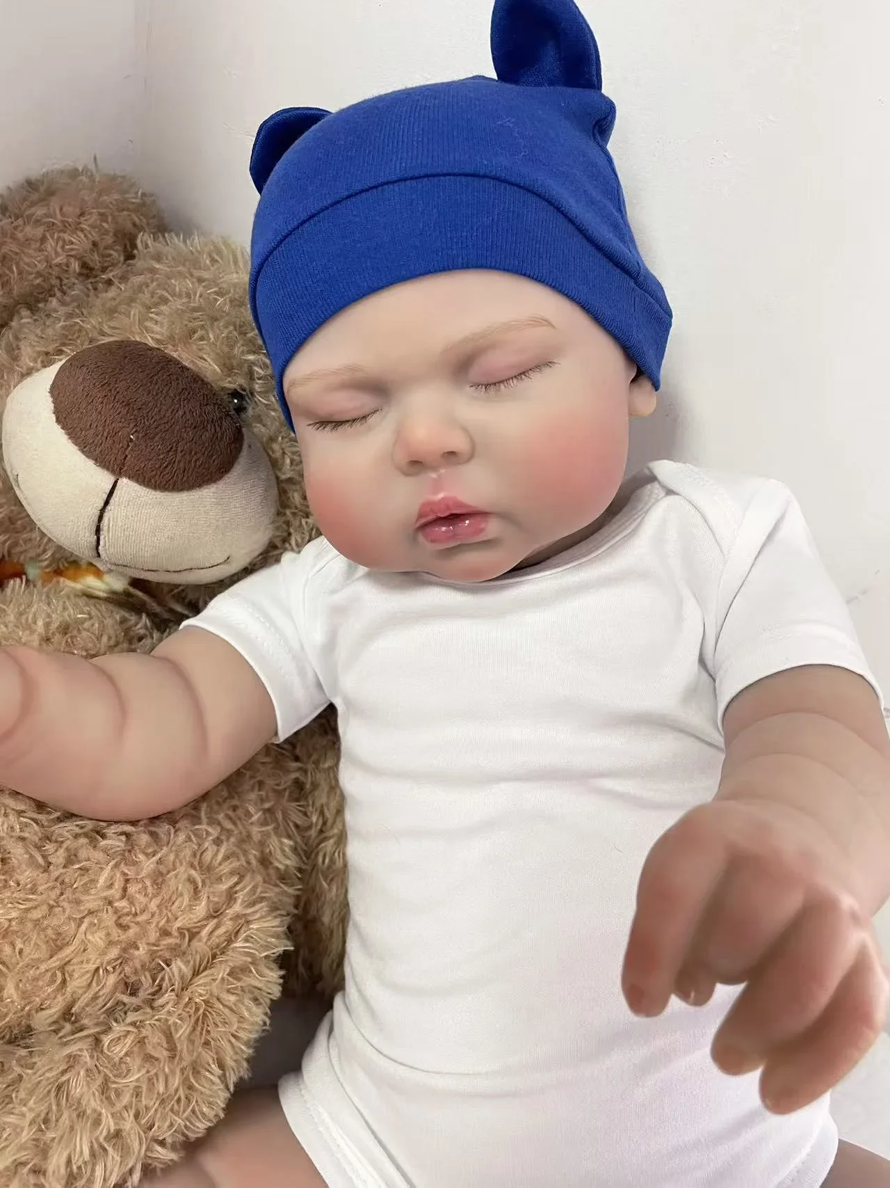 24Inch Reborn Doll Pickle Wearing a dark blue hat and a white short sleeved jumpsuit Multiple Layers Painting Hand Root Hair