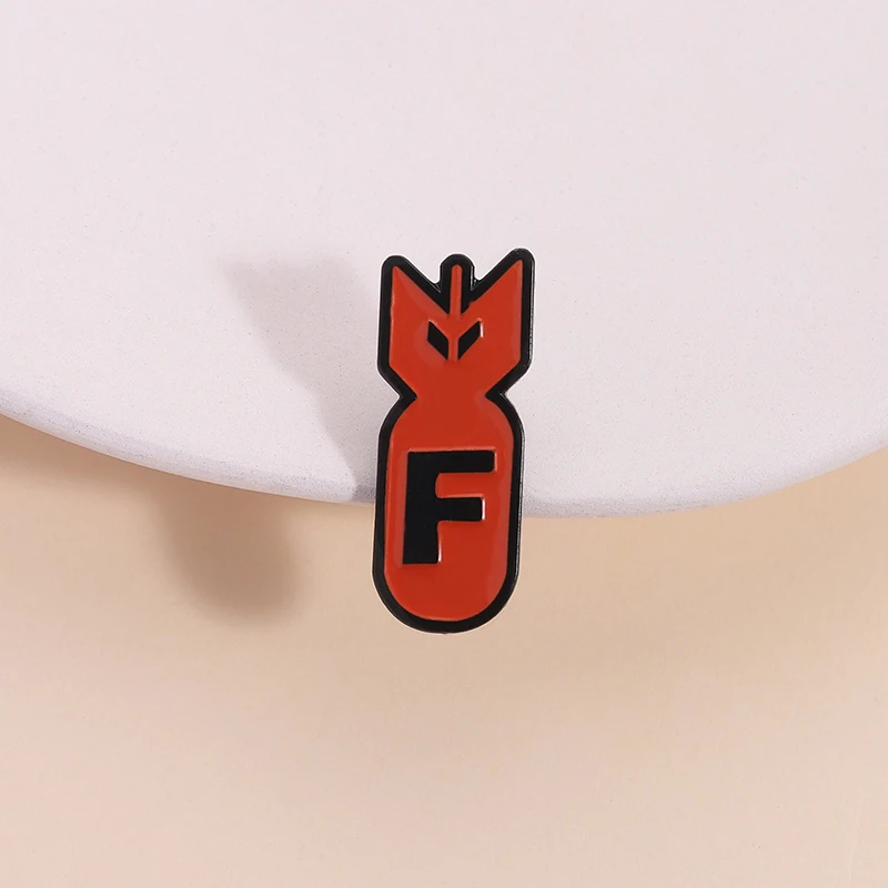

The Design Of The Orange Red Bomb Enamel Pin Black Arrow Letter 'F' Identification Brooch Lapel Badge Wholesale Jewelry Gift