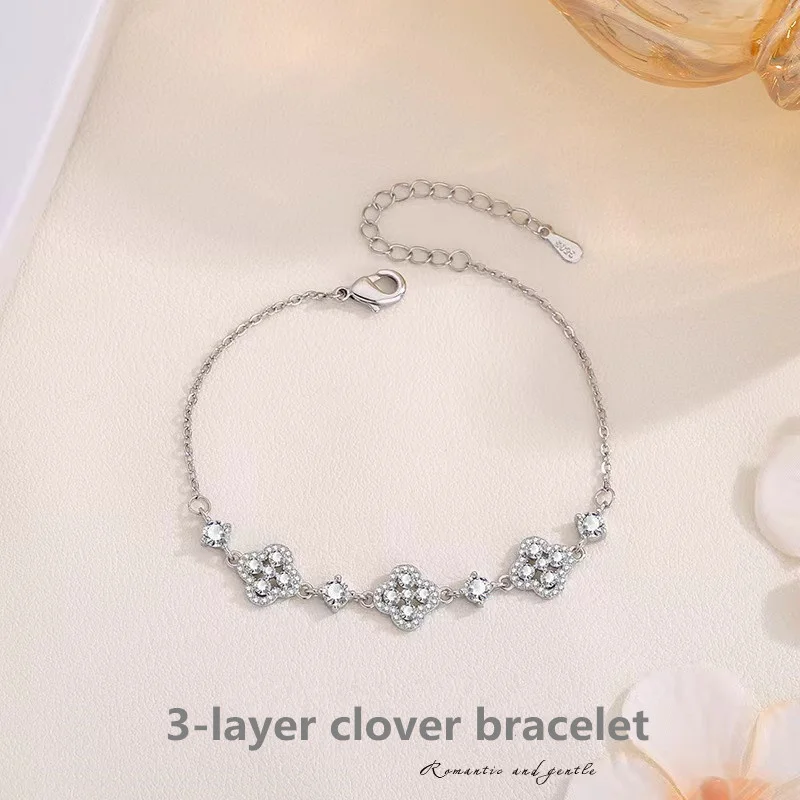 

Triple Layered Four-Leaf Clover Bracelet with Sparkling Inlay - Elegant Handcrafted Jewelry for Luck and Style