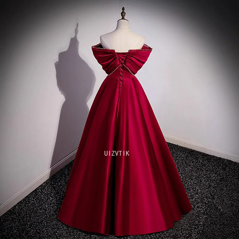 فستان حفلة موسيقية أنيق باللون العنابي للنساء بدون أكتاف بفيونكة كبيرة مناسبة للحفلات المسائية فساتين مناسبة رسمية مخصصة