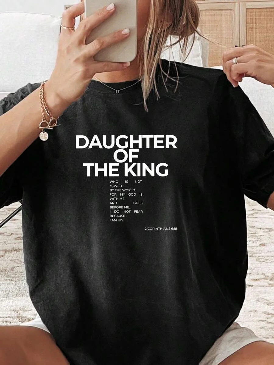 

Plus - Size Religious Inspirational Tee, Black Short - Sleeve with “DAUGHTER OF THE KING” & Bible Verse