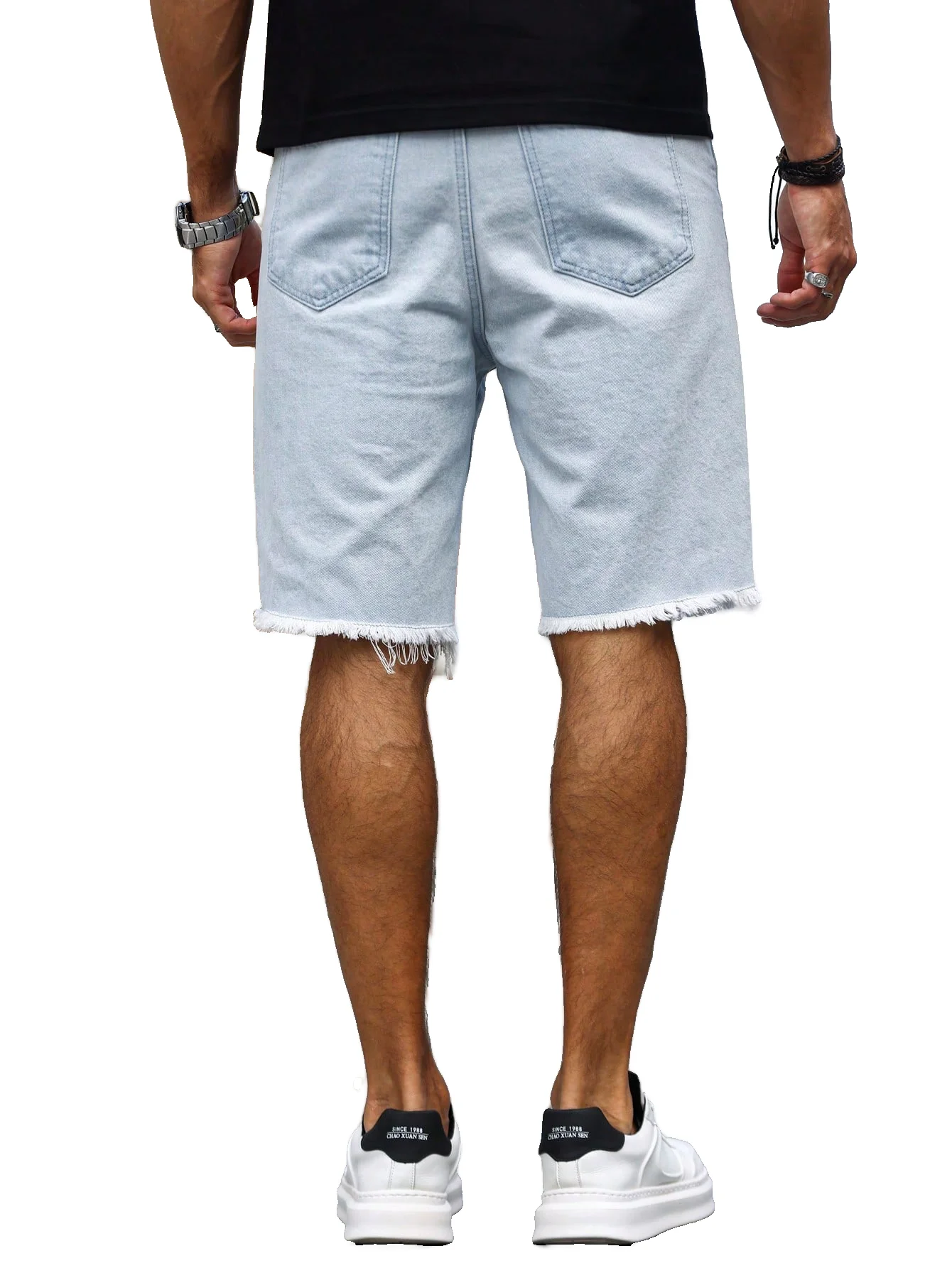 Men's light blue ripped denim shorts with patches for summer. Frayed edge design, showcasing street - style and a casual vibe.
