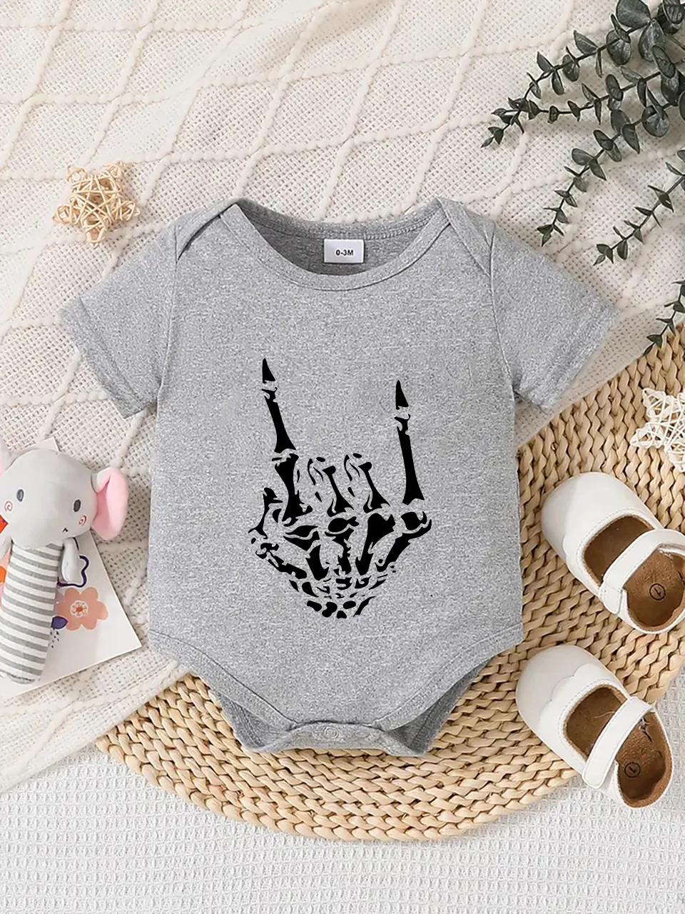 Playful letter-printed baby short-sleeve triangle bodysuit. Button closure for easy dressing, machine washable