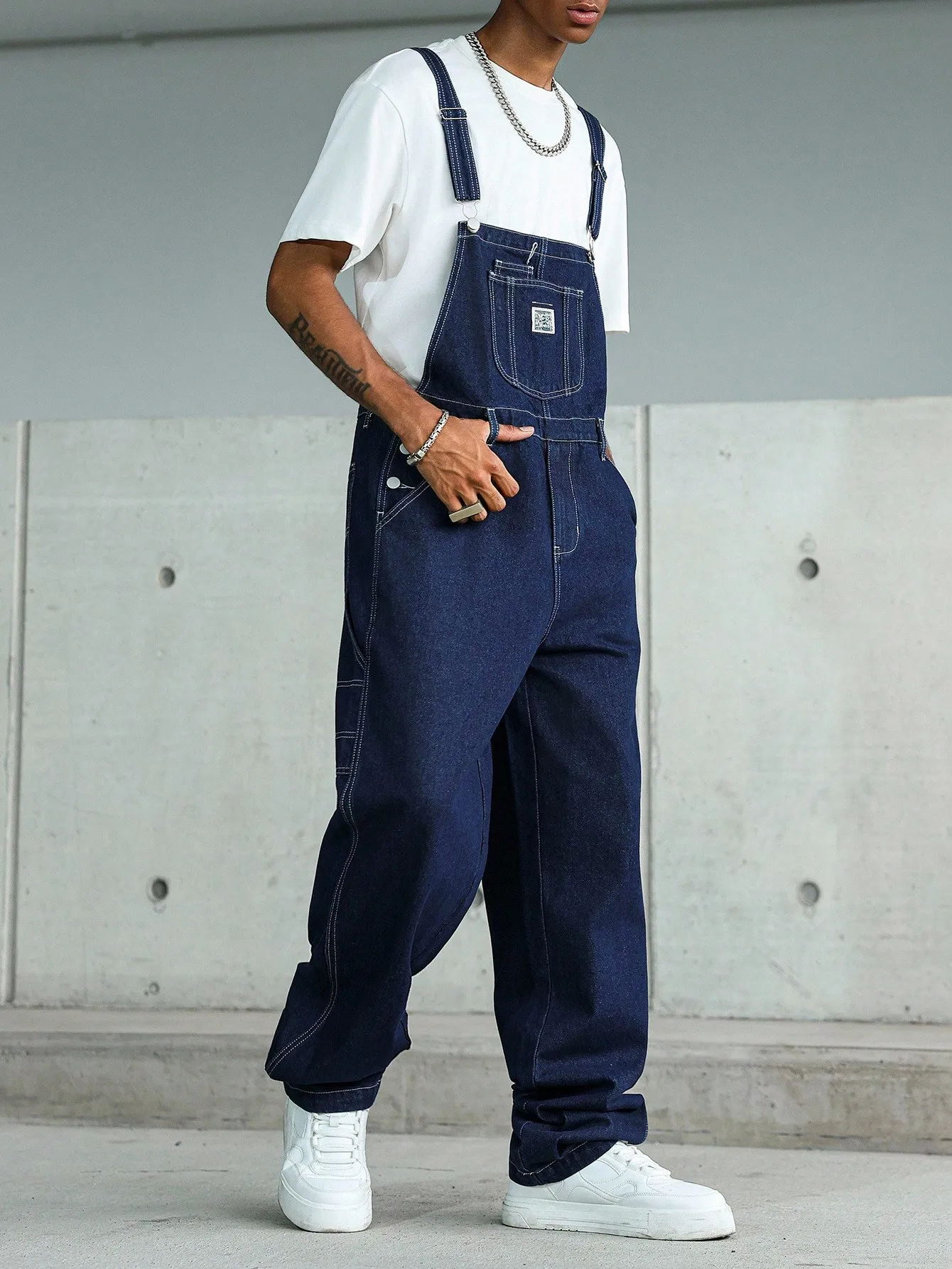 High-quality blue washed multi-pocket denim cargo pants with adjustable shoulder straps, perfect for casual wear in all seasons.