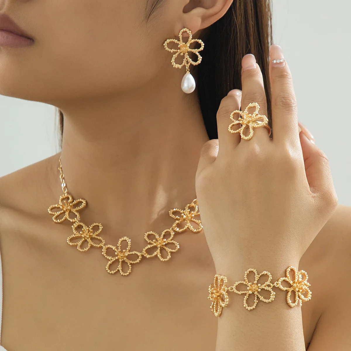 

4 Piece Jewelry Set Elegant Ladies Women Faux Pearl Gold Plated Metal Line Hollow Flower Ring Bracelet Necklace and Earrings