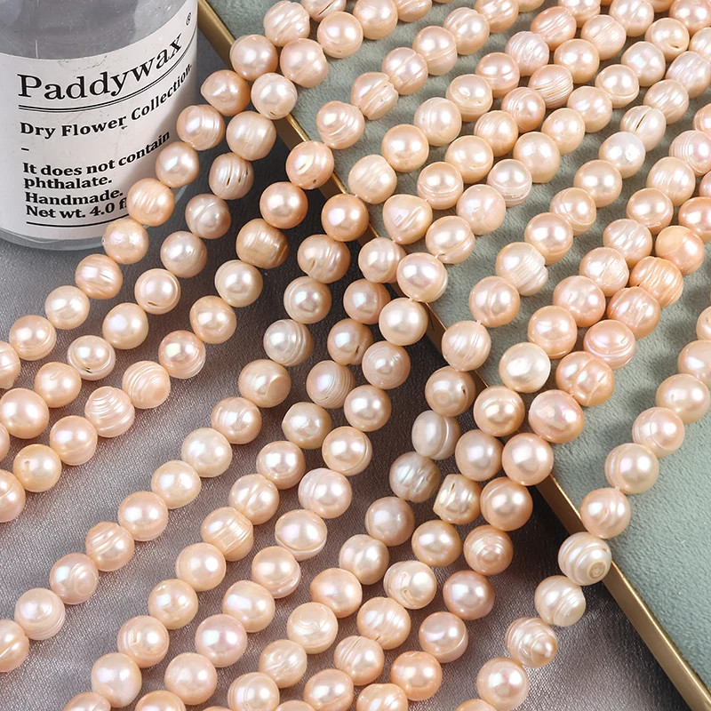 10mm potato-shaped threaded, seedless natural freshwater pink-orange pearls, approximately 35 cm in length, about 35 pieces.