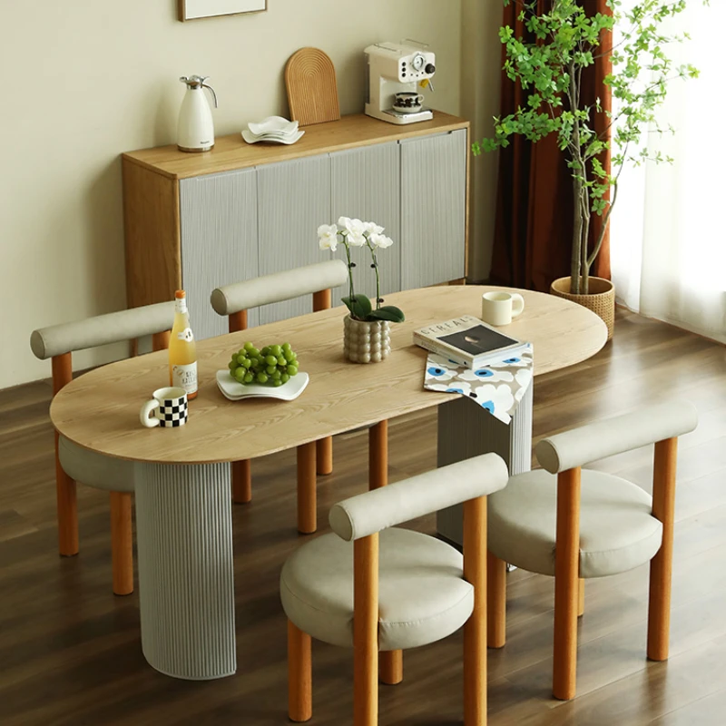 

My rice home dining table modern simple small apartment Nordic oval dining table 4-6 person dining table and chair combination.