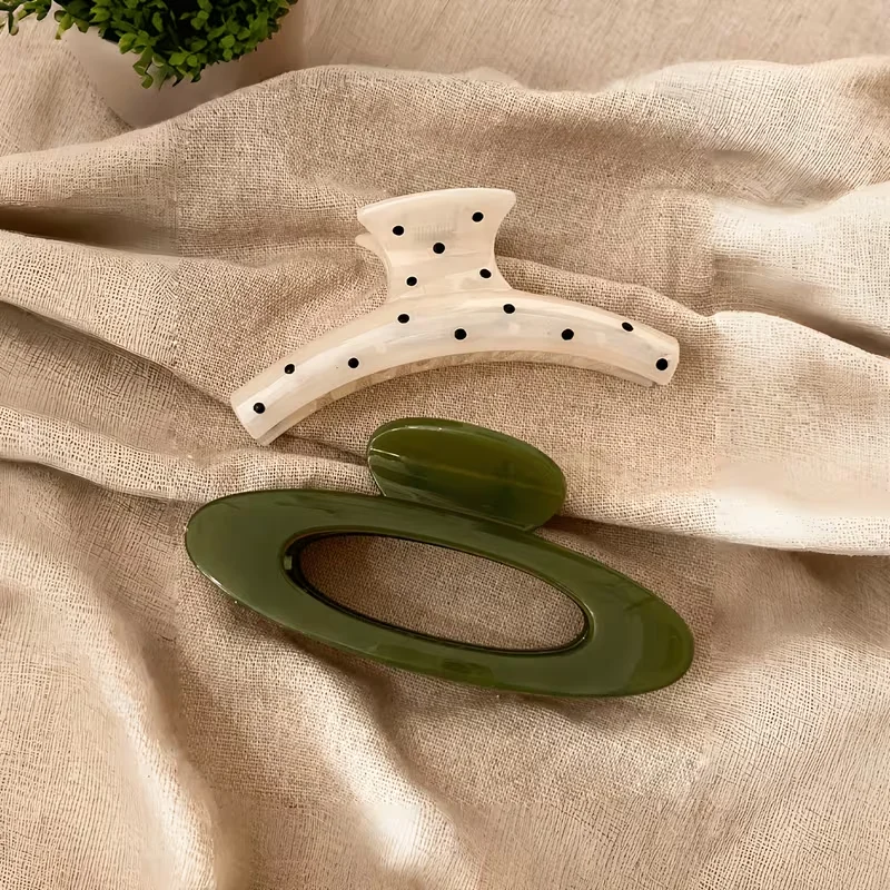 Large, lightweight plastic claw clip for women; oval design featuring a green-and-white polka-dot pattern; stylish, versatile, e view 4