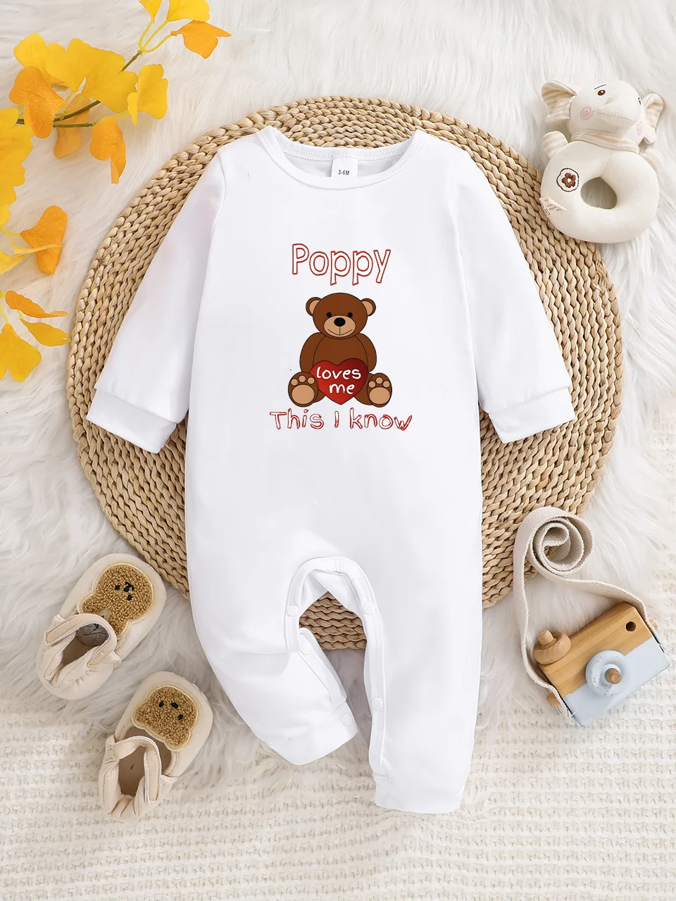 A baby long-sleeved onesie with interesting letter prints. It features a buttoned design for easy putting on and taking off
