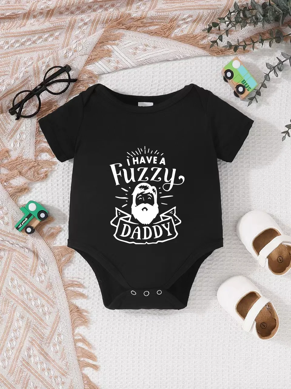 Playful letter-printed baby short-sleeve triangle bodysuit. Button closure for easy dressing