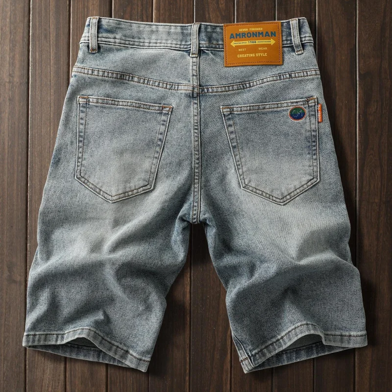 Soft cotton stretch denim shorts with delicate embroidery patterns, slim straight cut, versatile five-inch casual shorts for men