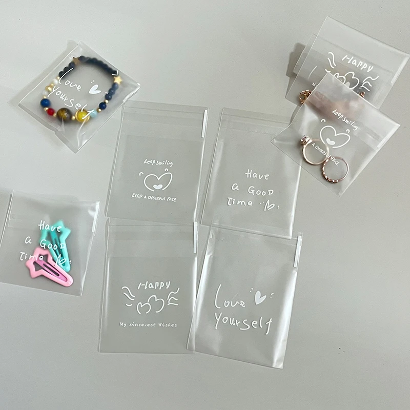 100pcs Printed Jewelry Packaging Bags Cute Heart Pattern Transparent Self‑Sealing Pouch for Earrings Rings Bracelets Small Gift