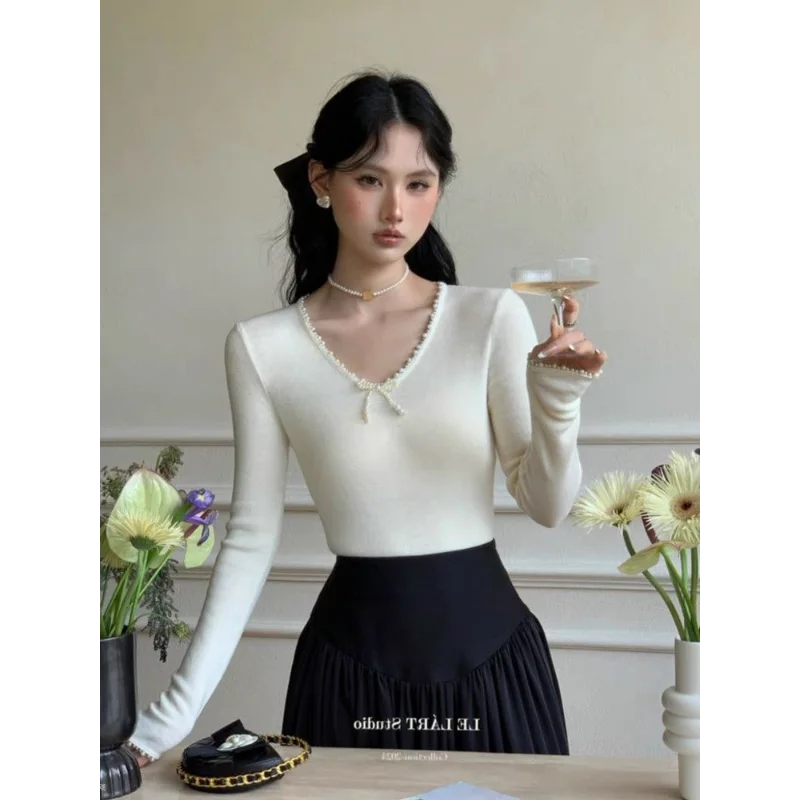 

New Women's Spliced temperament Pure Lust Pearl Bow Long-sleeved Knitted Slim Fit Top