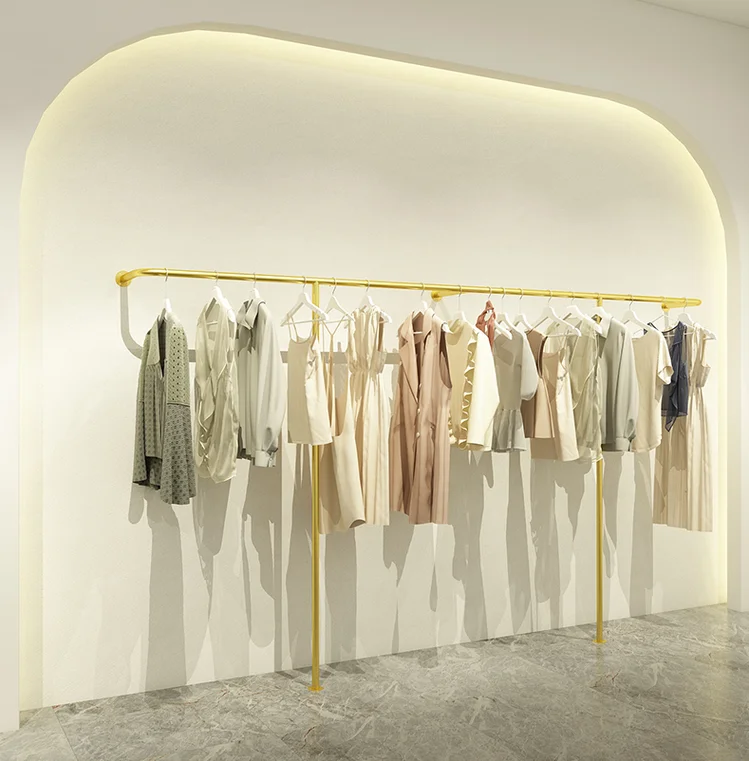 

Clothing store display shelves on the wall Women's and children's clothing hanging against the wall Clothes rack shelves